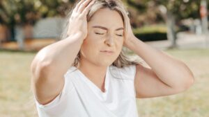 Woman holding head, suffering with bad headache